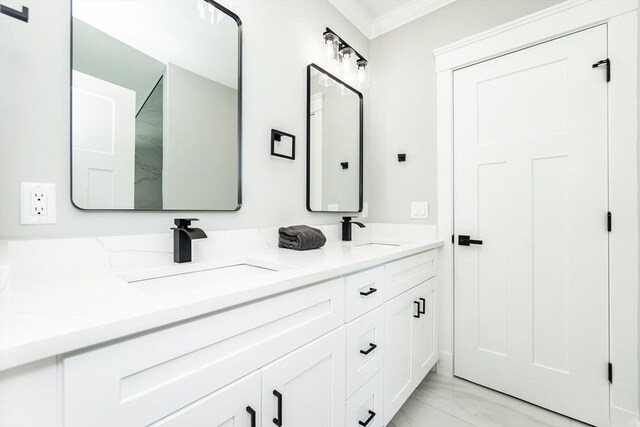 bathroom with a sink, crown molding, double vanity, and marble finish floor