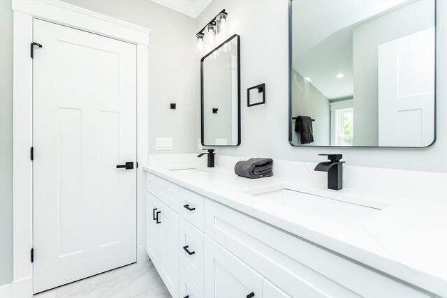 full bath featuring double vanity, a sink, marble finish floor, and recessed lighting