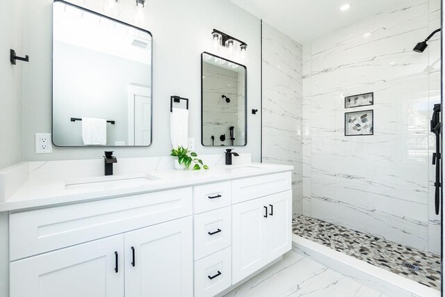 full bathroom with a marble finish shower, a sink, and marble finish floor