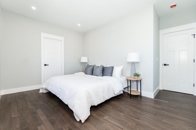 bedroom with dark wood-type flooring, recessed lighting, and baseboards