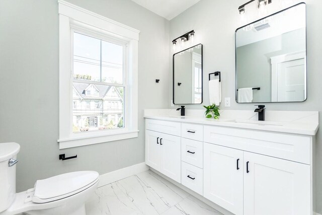 full bathroom with a sink, baseboards, toilet, and marble finish floor