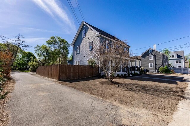 view of side of home with fence and a residential view