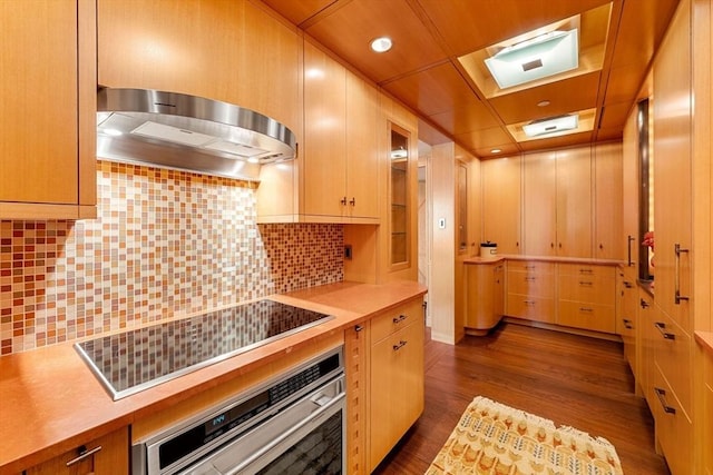 2 Commonwealth Ave Unit 14B, Boston, MA 02116 - kitchen with dark wood-style flooring, oven, black electric stovetop, range hood, and light countertops