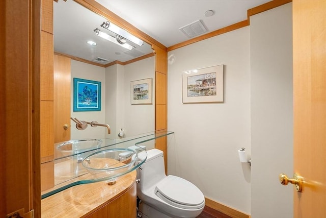 2 Commonwealth Ave Unit 14B, Boston, MA 02116 - half bathroom with visible vents, crown molding, toilet, and vanity