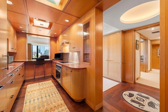 2 Commonwealth Ave Unit 14B, Boston, MA 02116 - kitchen with stainless steel appliances, recessed lighting, backsplash, dark wood-style floors, and glass insert cabinets