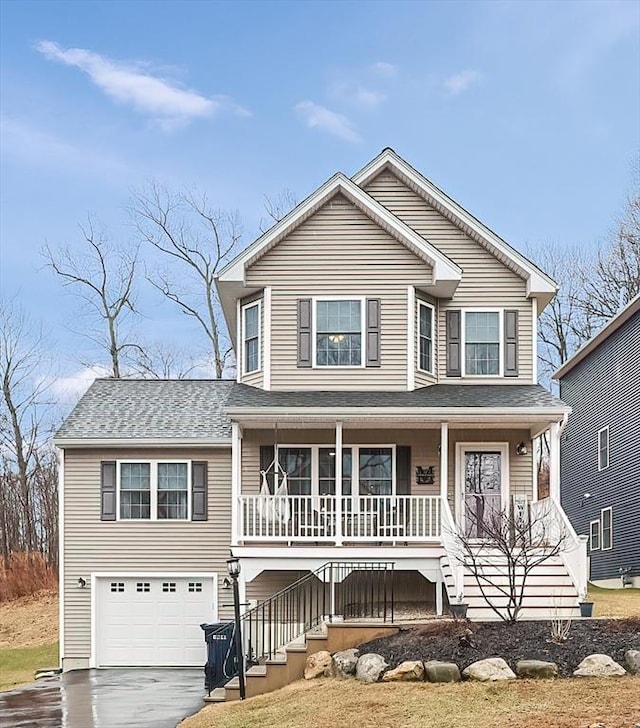 view of front facade with an attached garage, stairs, driveway, covered porch, and a shingled roof