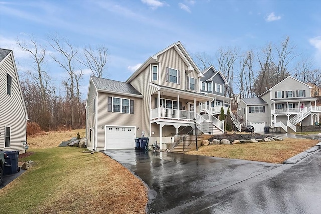 view of front facade featuring stairs, driveway, a front yard, covered porch, and a garage