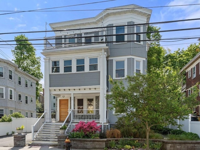 117 Sycamore St Unit 1, Boston, MA 02131 - view of front of house featuring a balcony, covered porch, fence, and stairway