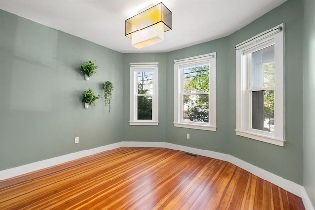 117 Sycamore St Unit 1, Boston, MA 02131 - spare room with hardwood / wood-style flooring and baseboards