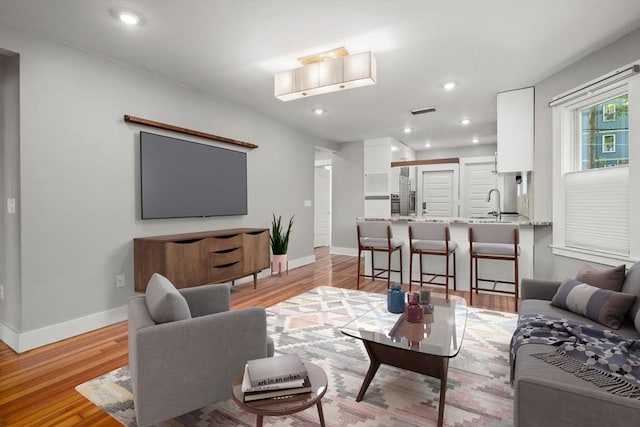 117 Sycamore St Unit 1, Boston, MA 02131 - living room with light wood-style flooring, baseboards, and recessed lighting