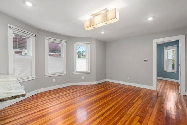 117 Sycamore St Unit 1, Boston, MA 02131 - empty room with wood finished floors, baseboards, and recessed lighting