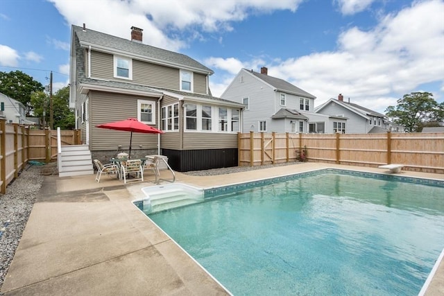 24 Neponset Rd, Quincy, MA 02169 - back of property featuring a fenced backyard, a patio, and a chimney