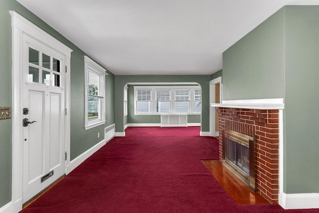 24 Neponset Rd, Quincy, MA 02169 - unfurnished living room with a brick fireplace, baseboards, and carpet flooring