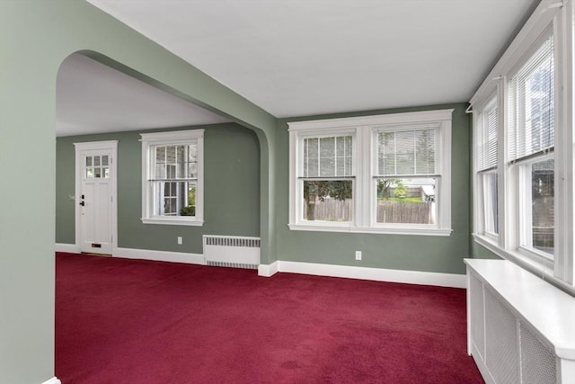 24 Neponset Rd, Quincy, MA 02169 - empty room with radiator heating unit, dark carpet, and baseboards