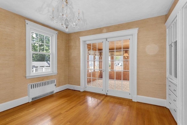 24 Neponset Rd, Quincy, MA 02169 - interior space with radiator, baseboards, a chandelier, and wood finished floors