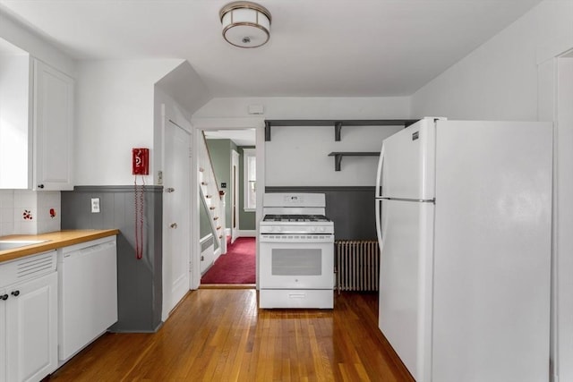 24 Neponset Rd, Quincy, MA 02169 - kitchen featuring white appliances, radiator, white cabinetry, hardwood / wood-style floors, and decorative backsplash