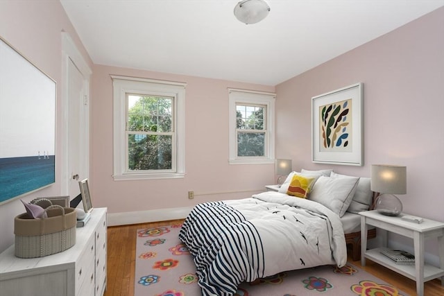 24 Neponset Rd, Quincy, MA 02169 - bedroom with wood finished floors, multiple windows, and baseboards