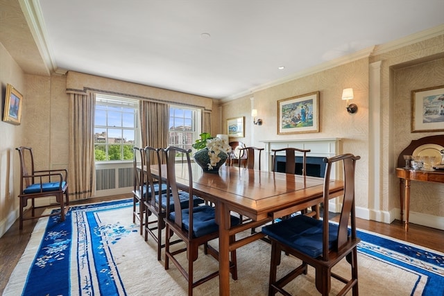 dining room featuring hardwood / wood-style flooring and ornamental molding