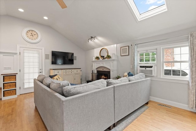 25 12th Ave, Halifax, MA 02338 - living area featuring lofted ceiling, light wood-type flooring, a lit fireplace, recessed lighting, and a ceiling fan