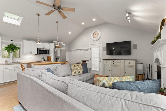 25 12th Ave, Halifax, MA 02338 - living area featuring a skylight, light wood-style floors, ceiling fan, recessed lighting, and high vaulted ceiling