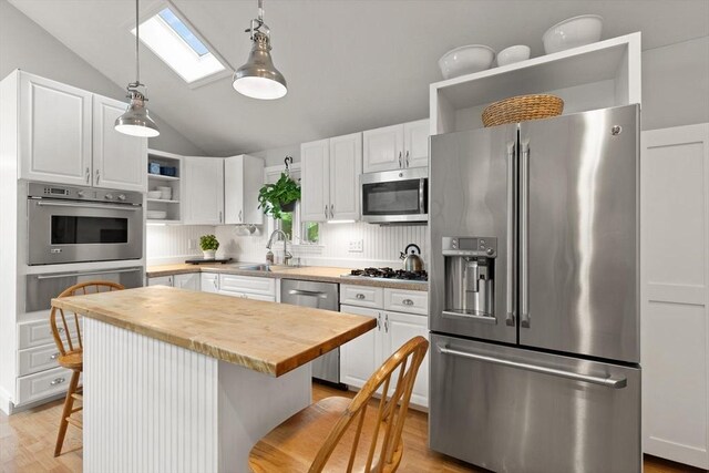 25 12th Ave, Halifax, MA 02338 - kitchen with stainless steel appliances, open shelves, wood counters, a skylight, and vaulted ceiling
