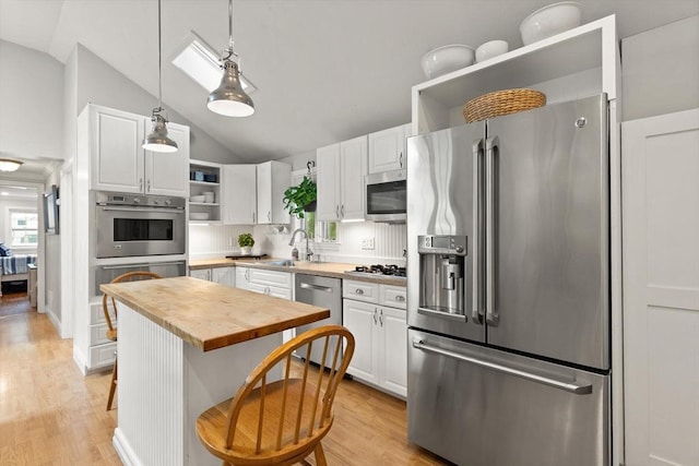 25 12th Ave, Halifax, MA 02338 - kitchen with stainless steel appliances, open shelves, vaulted ceiling, white cabinets, and butcher block countertops
