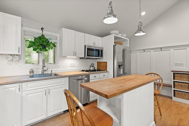 25 12th Ave, Halifax, MA 02338 - kitchen with stainless steel appliances, wood counters, a breakfast bar area, a decorative wall, and white cabinetry