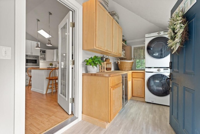 25 12th Ave, Halifax, MA 02338 - washroom with stacked washer and clothes dryer, light wood-style flooring, beverage cooler, and ornamental molding