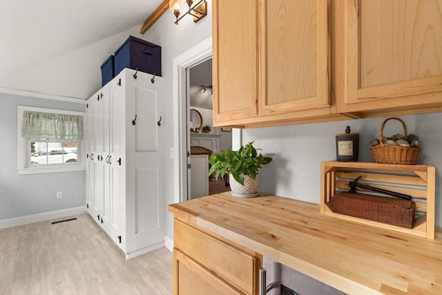 25 12th Ave, Halifax, MA 02338 - kitchen with butcher block countertops, vaulted ceiling, light wood finished floors, and light brown cabinets