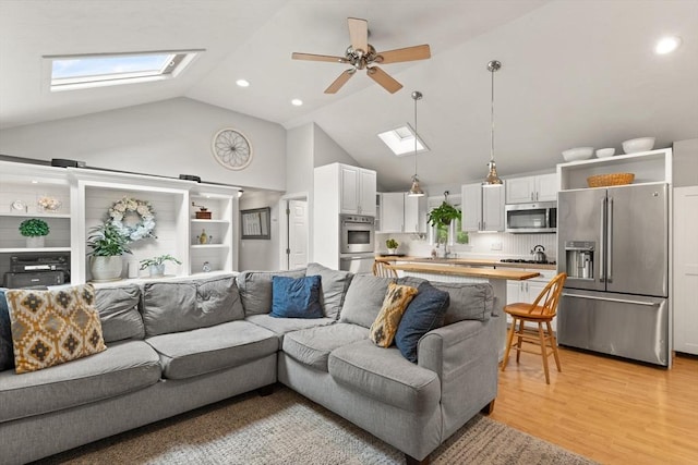 25 12th Ave, Halifax, MA 02338 - living room with a skylight, high vaulted ceiling, a ceiling fan, light wood-type flooring, and recessed lighting