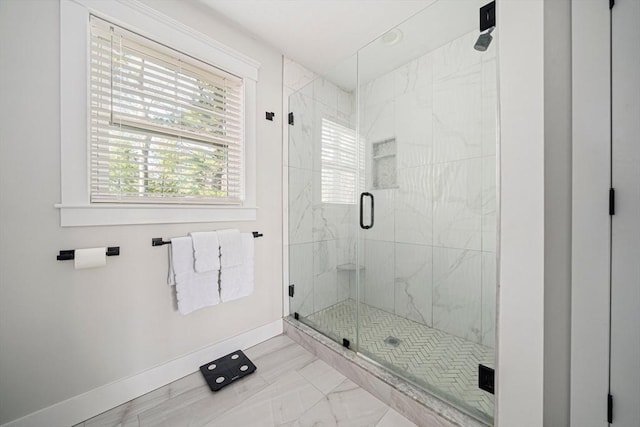 full bath featuring baseboards, a marble finish shower, and marble finish floor