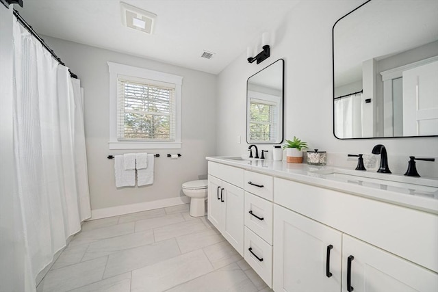 bathroom with a sink, baseboards, toilet, and marble finish floor