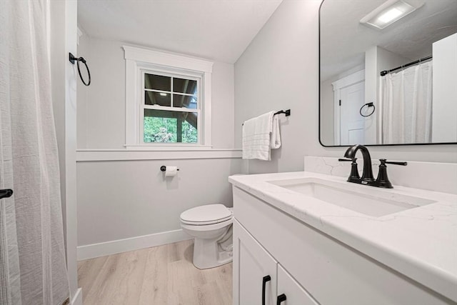 full bath with vanity, wood finished floors, toilet, baseboards, and a shower with curtain