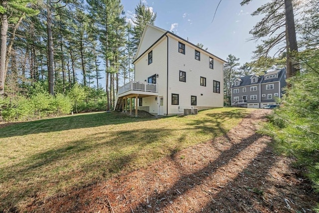 back of house with a wooden deck, stairs, a yard, and central AC