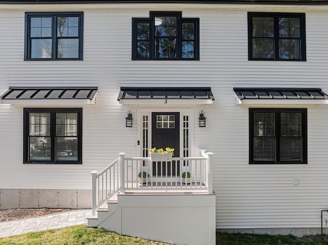 view of front of house featuring a standing seam roof and metal roof