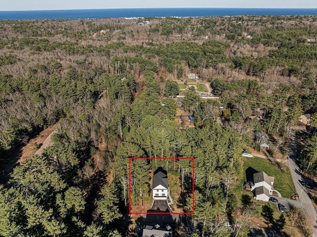 bird's eye view featuring a wooded view