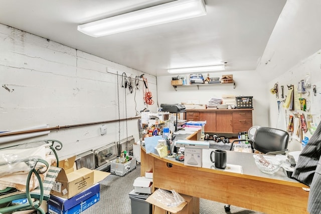 home office with carpet flooring and a workshop area