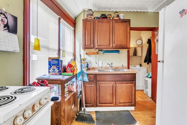 kitchen with light hardwood / wood-style floors, white range with electric stovetop, and sink