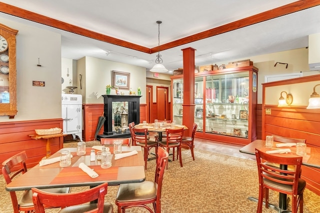 dining room with wood walls