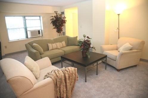 108 Peterborough St Unit 4F, Boston, MA 02215 - living room featuring cooling unit, light carpet, and baseboards