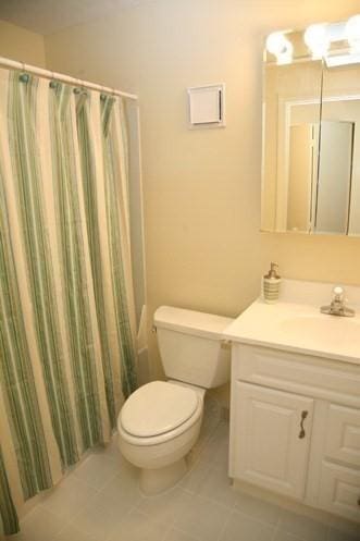 108 Peterborough St Unit 4F, Boston, MA 02215 - bathroom with a shower with shower curtain, vanity, toilet, and tile patterned floors