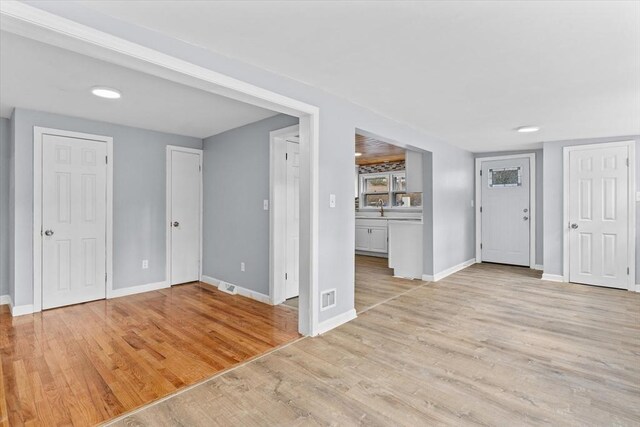 260 Great Rd, Stow, MA 01775 - unfurnished living room with light wood finished floors, baseboards, and visible vents