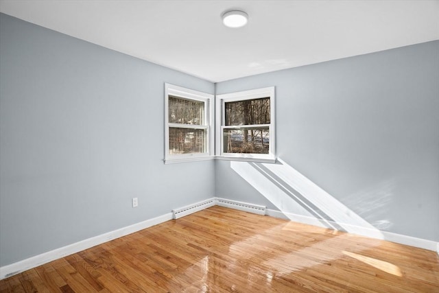 260 Great Rd, Stow, MA 01775 - unfurnished room featuring wood finished floors, a baseboard heating unit, and baseboards