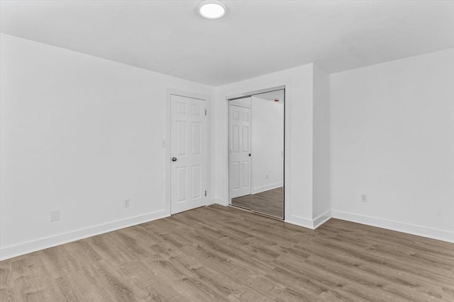 260 Great Rd, Stow, MA 01775 - unfurnished bedroom featuring a closet, baseboards, and wood finished floors