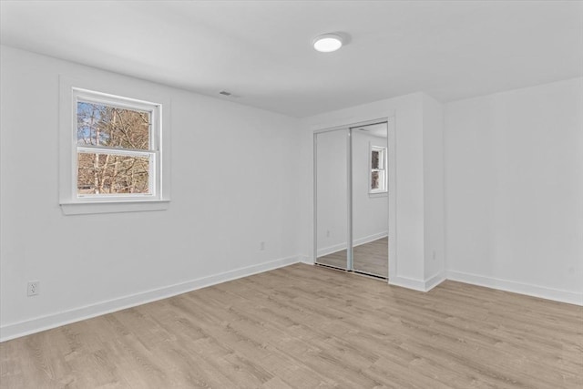260 Great Rd, Stow, MA 01775 - unfurnished bedroom featuring a closet, light wood finished floors, and baseboards