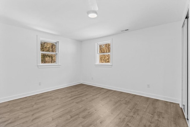 260 Great Rd, Stow, MA 01775 - empty room with plenty of natural light, baseboards, and wood finished floors