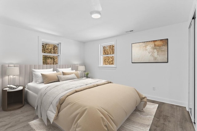 260 Great Rd, Stow, MA 01775 - bedroom with multiple windows, baseboards, and wood finished floors