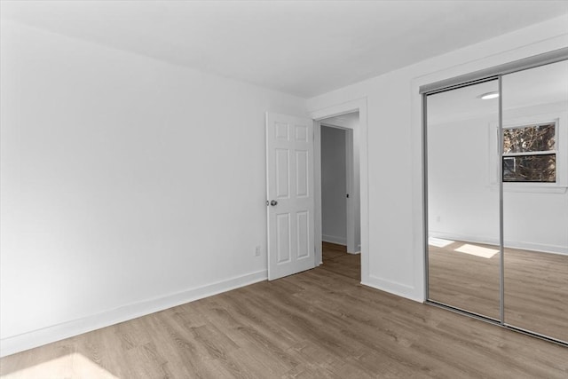 260 Great Rd, Stow, MA 01775 - unfurnished bedroom with a closet, baseboards, and wood finished floors