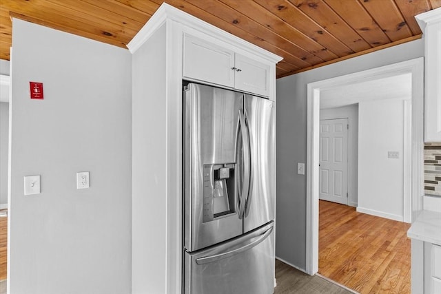 260 Great Rd, Stow, MA 01775 - kitchen with light wood-style flooring, wood ceiling, white cabinetry, and stainless steel fridge