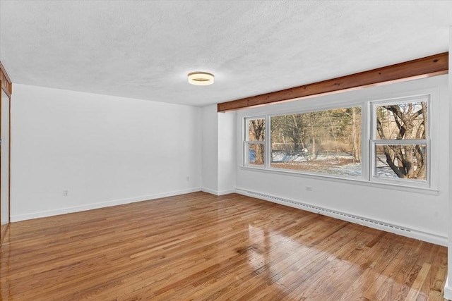 260 Great Rd, Stow, MA 01775 - empty room featuring baseboard heating, light wood-style floors, baseboards, and a textured ceiling